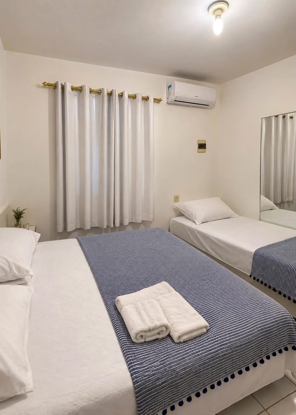 Quarto com cama de casal e cama auxiliar